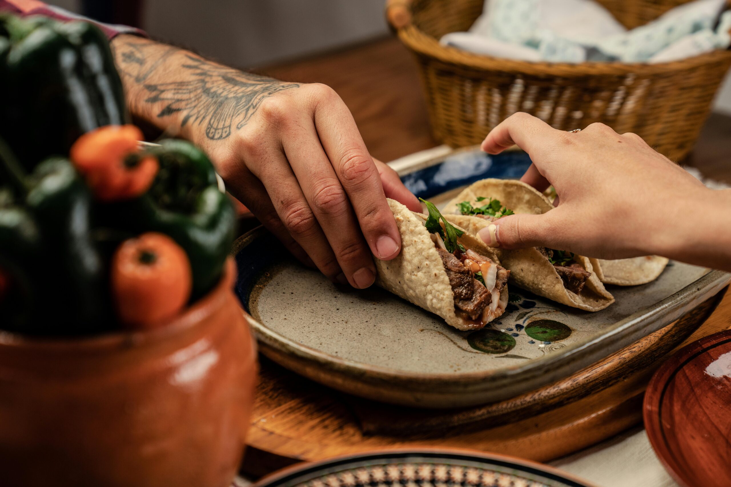 Bexar Bones Newsletter Hands reaching for tacos.